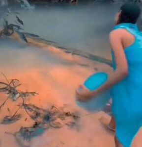 Watch|| Female traditional worshipper seen pouring money into river for the gods